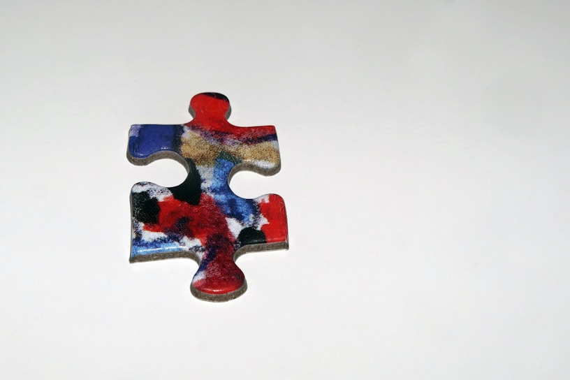 A colorful puzzle piece with English letters.
