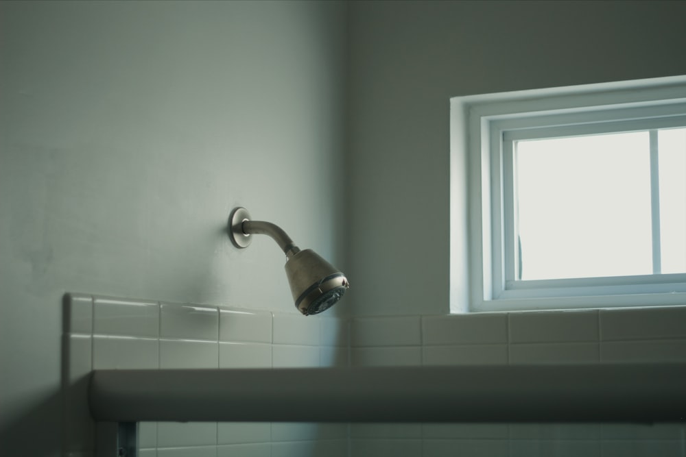 a bathroom sink with a faucet next to a window