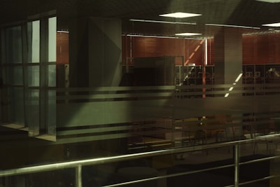 Modern office space featuring sleek roller blinds partially lowered.