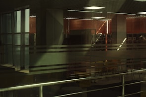 Modern office space featuring sleek glass partitions and roller blinds