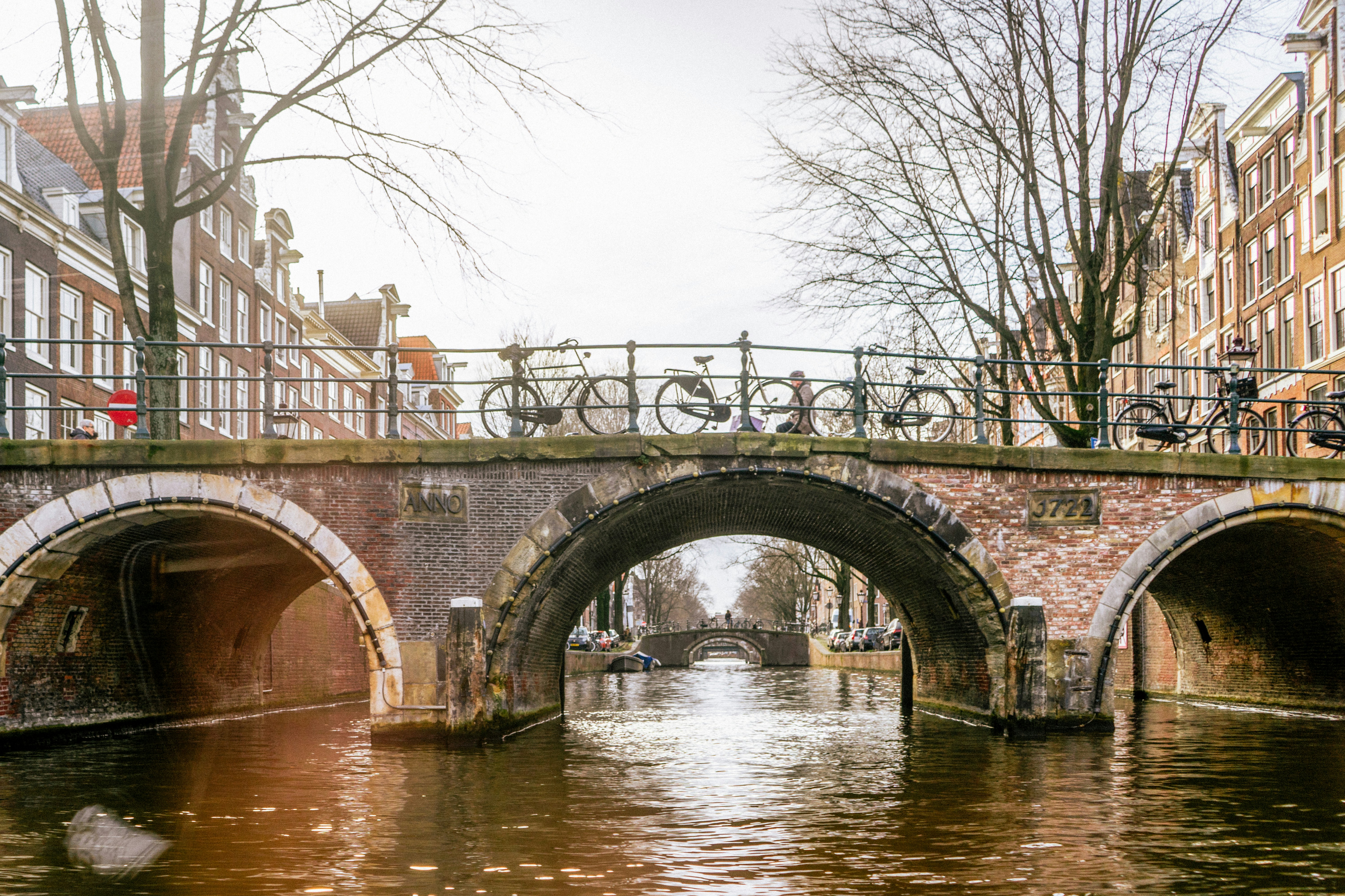 a bridge over a canal with bicycles on it
