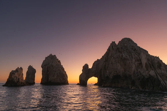 a group of rocks sitting on top of a body of water