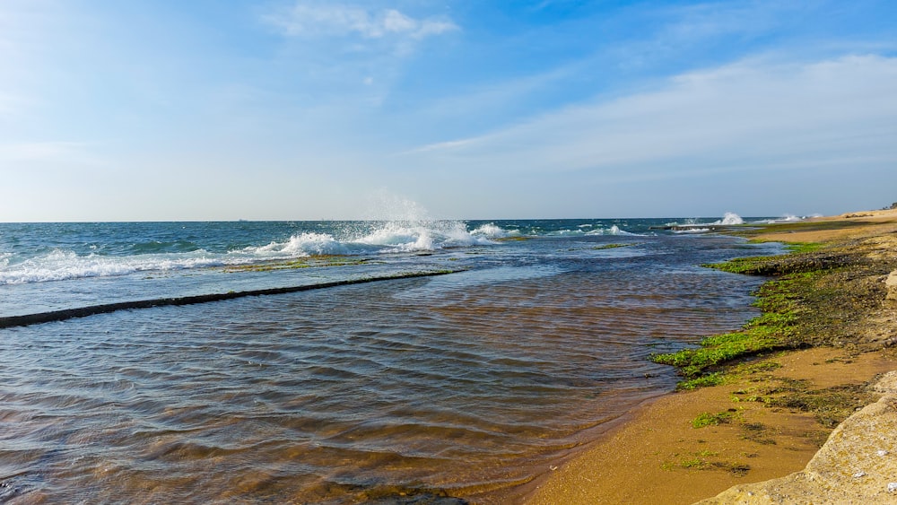 a body of water with waves coming in to shore