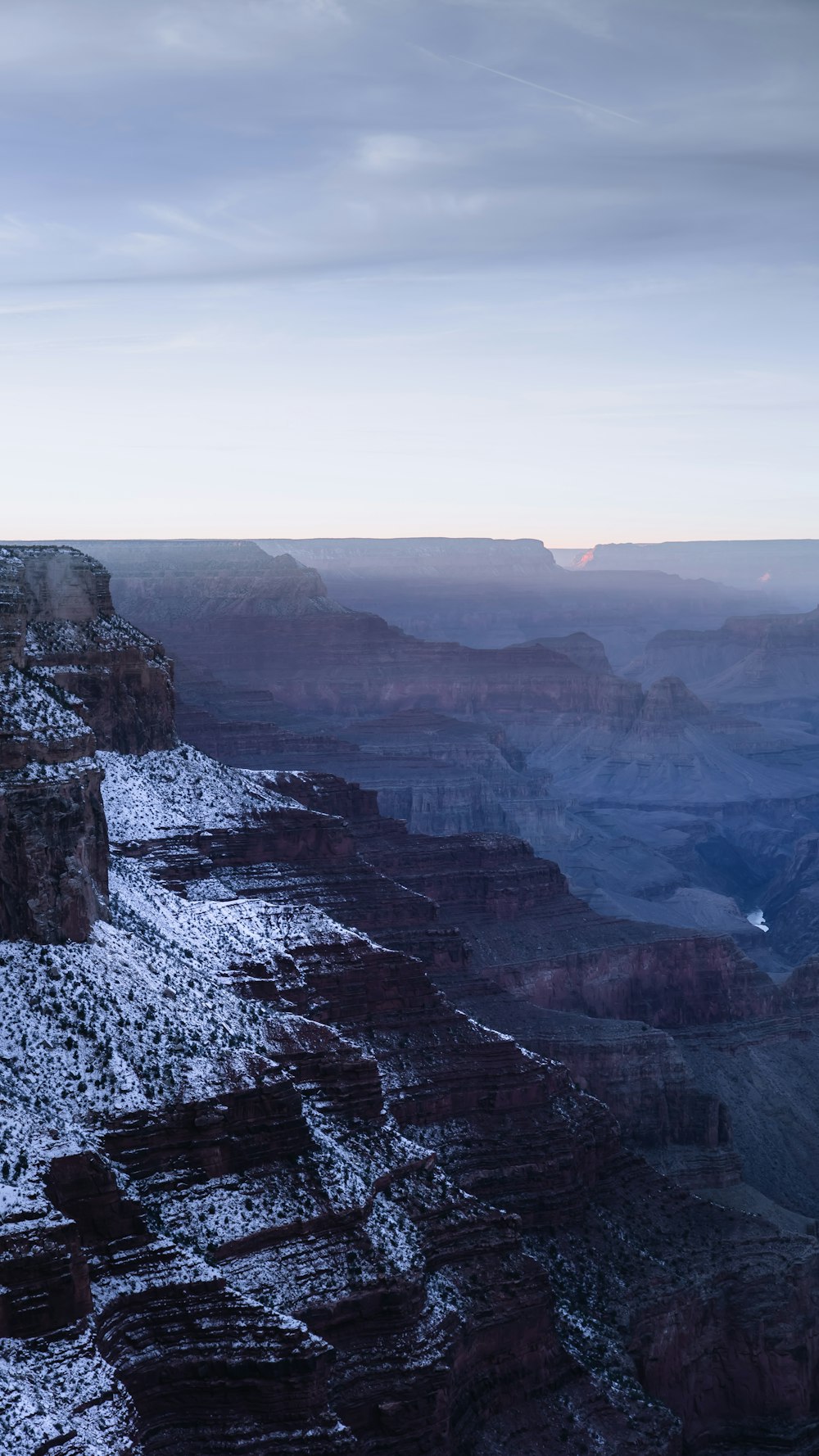 a view of the grand canyon in winter