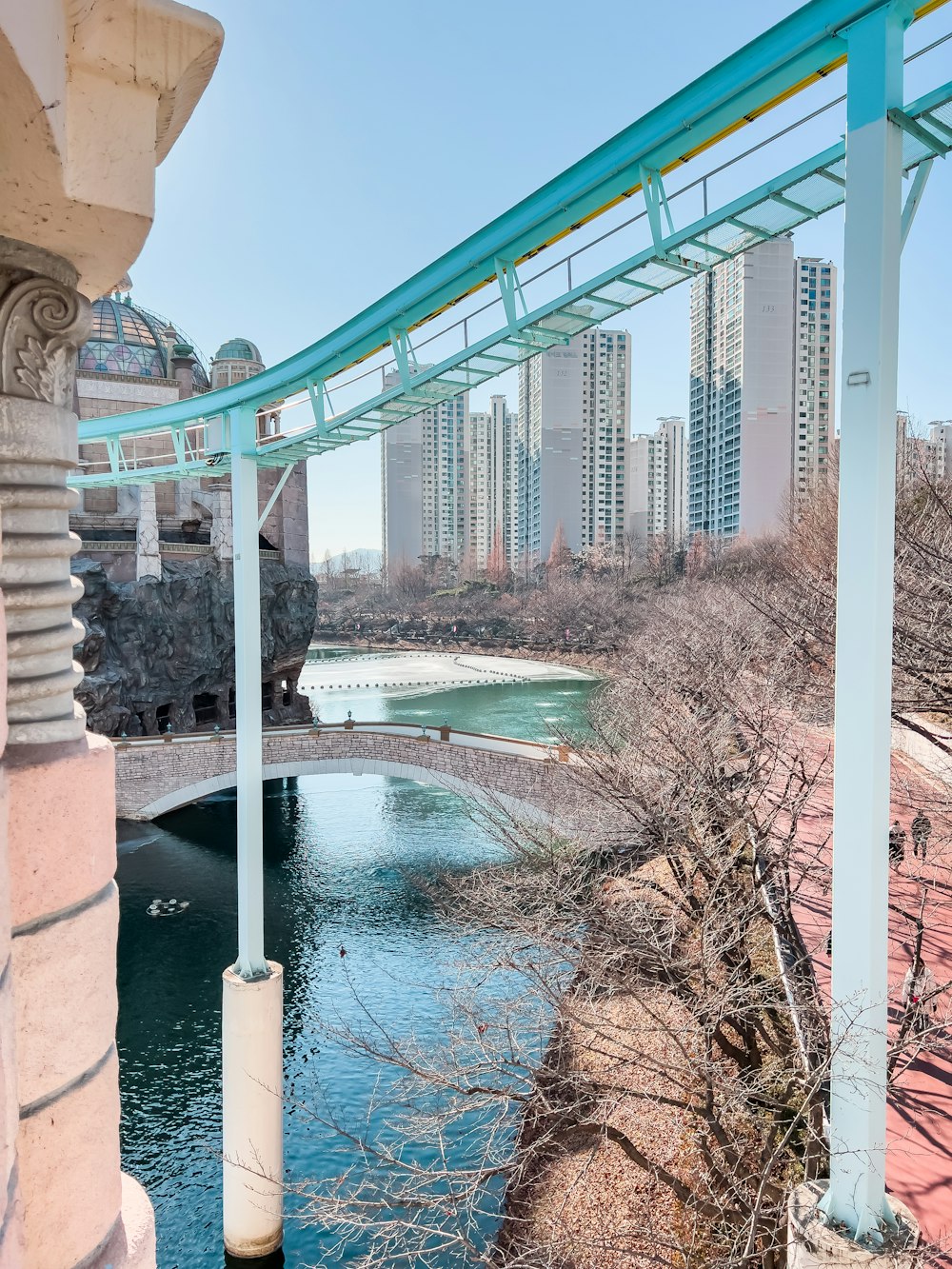 a bridge over a river next to tall buildings