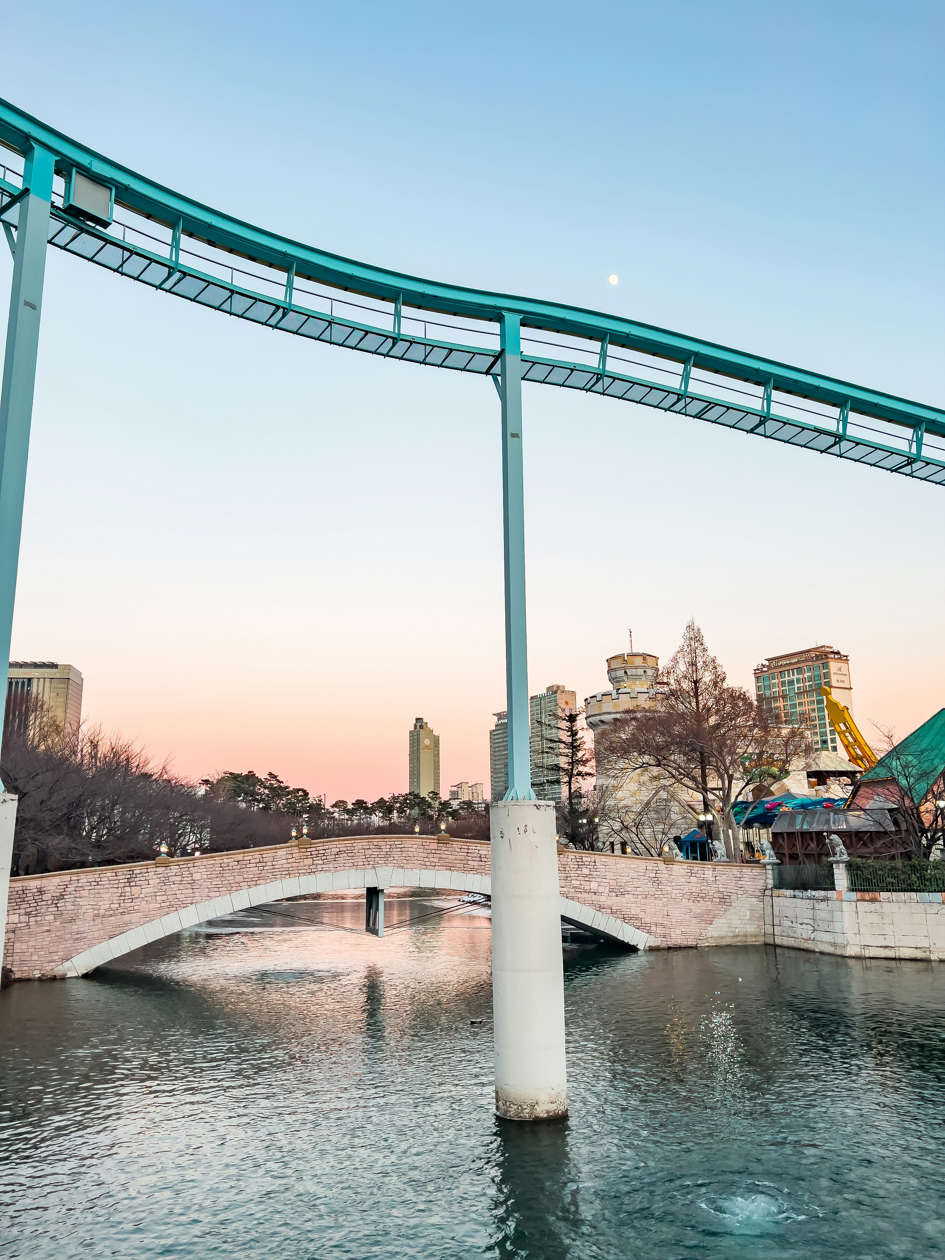 a bridge over a body of water with buildings in the background