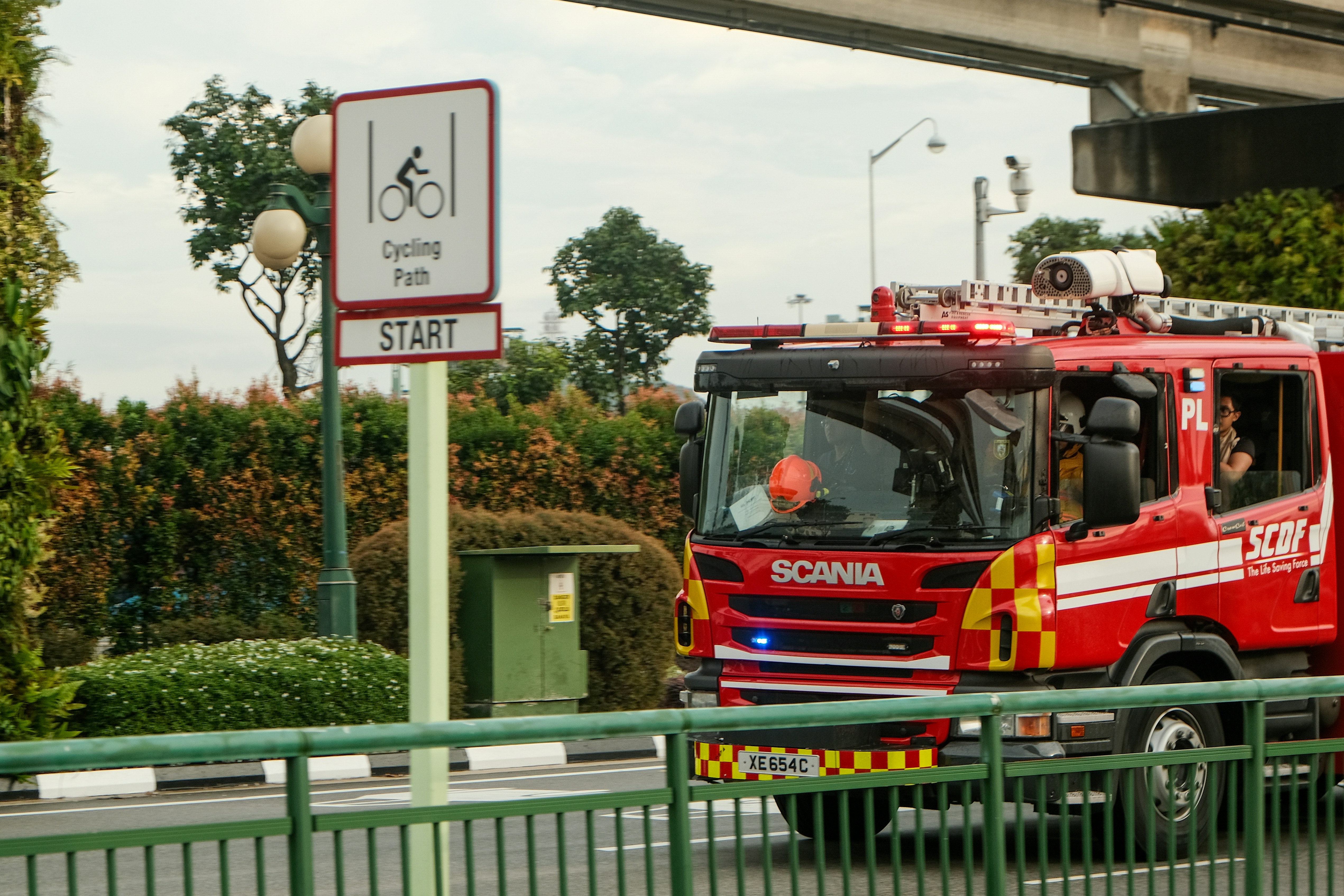 a red fire truck driving down a street