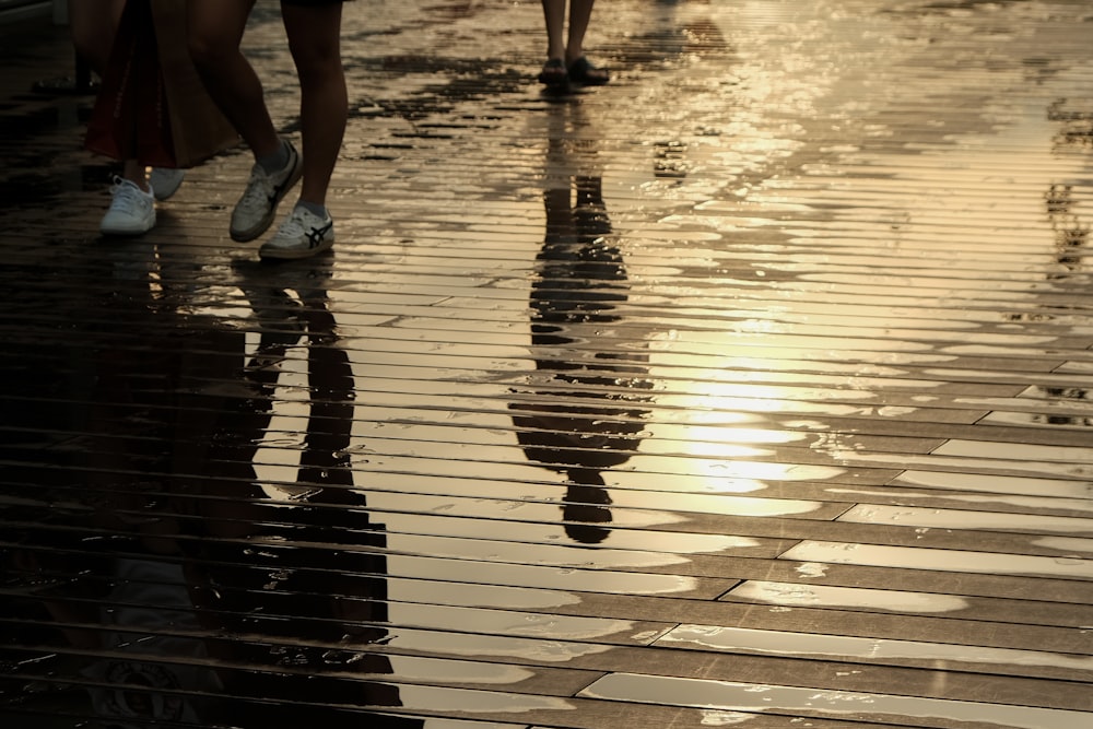 a couple of people that are walking in the rain