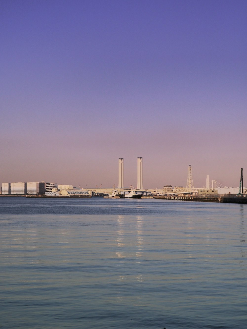 a large body of water with a city in the background