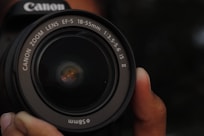 a close up of a person holding a camera