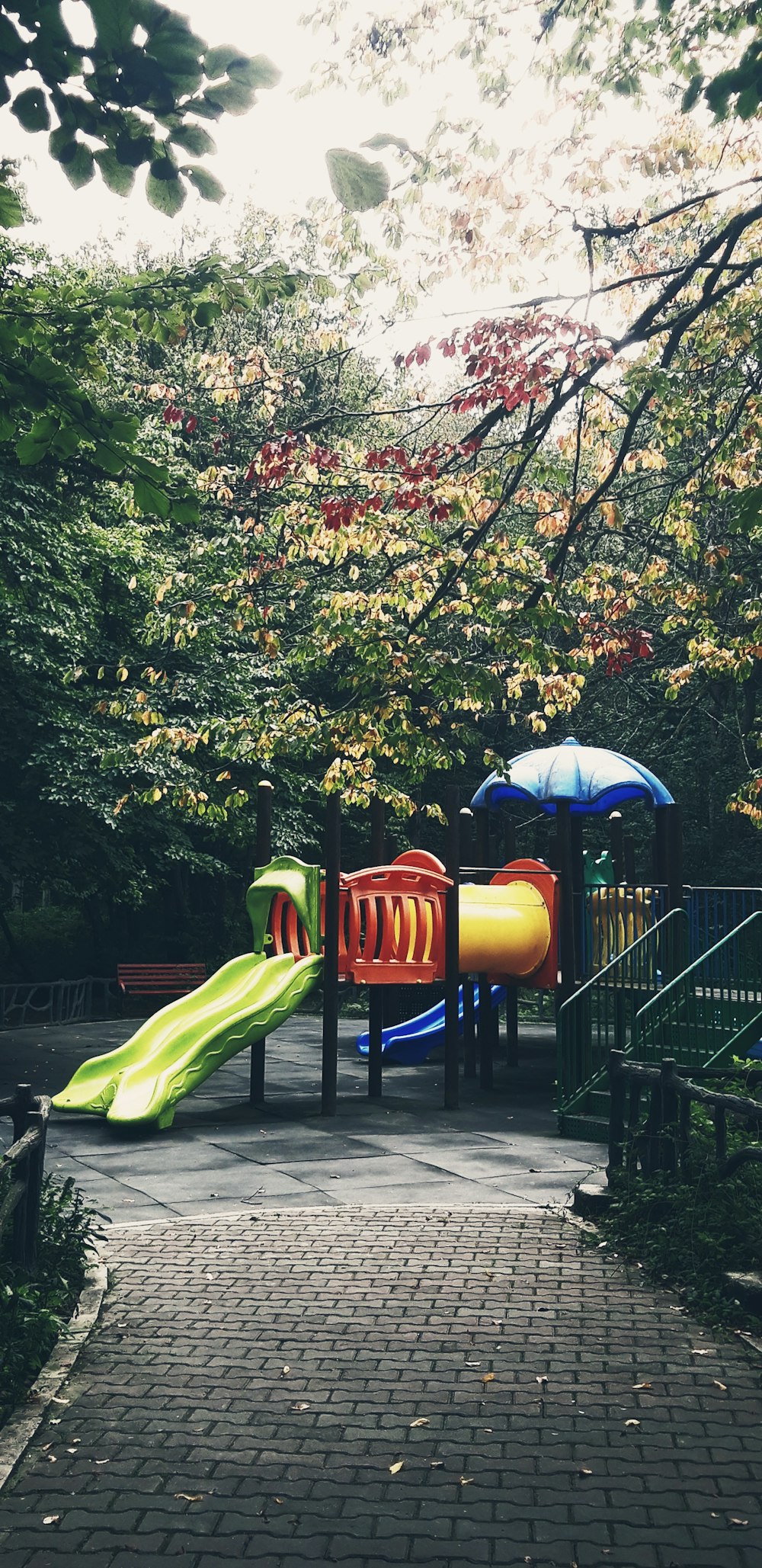a children's play area with a slide and umbrellas