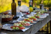 a wooden table topped with plates of food