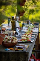 a long table covered with plates of food and bottles of wine