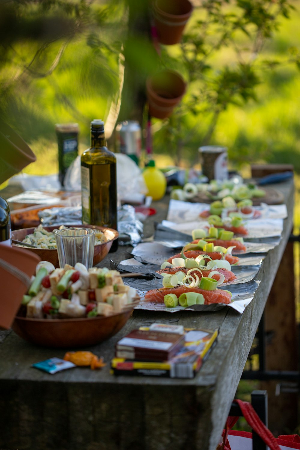 a long table covered with plates of food and bottles of wine