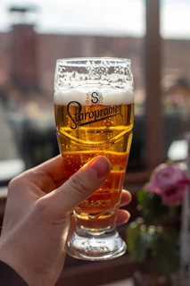Close-up of a frothy craft IPA poured into a branded Ježkove oči glass.
