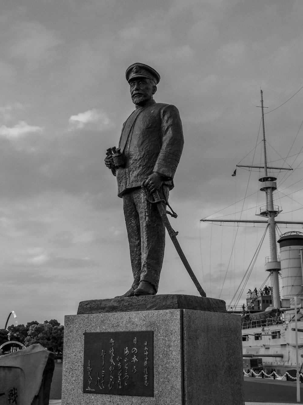 a black and white photo of a statue of a sailor