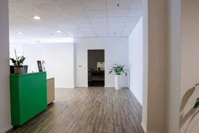 Clean and neat reception area of the clinic with green and white color scheme.