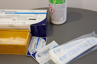 a table with a box of tissues and a can of medicine