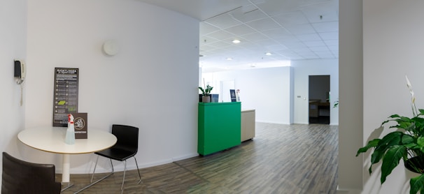a room with a white table and a green cabinet