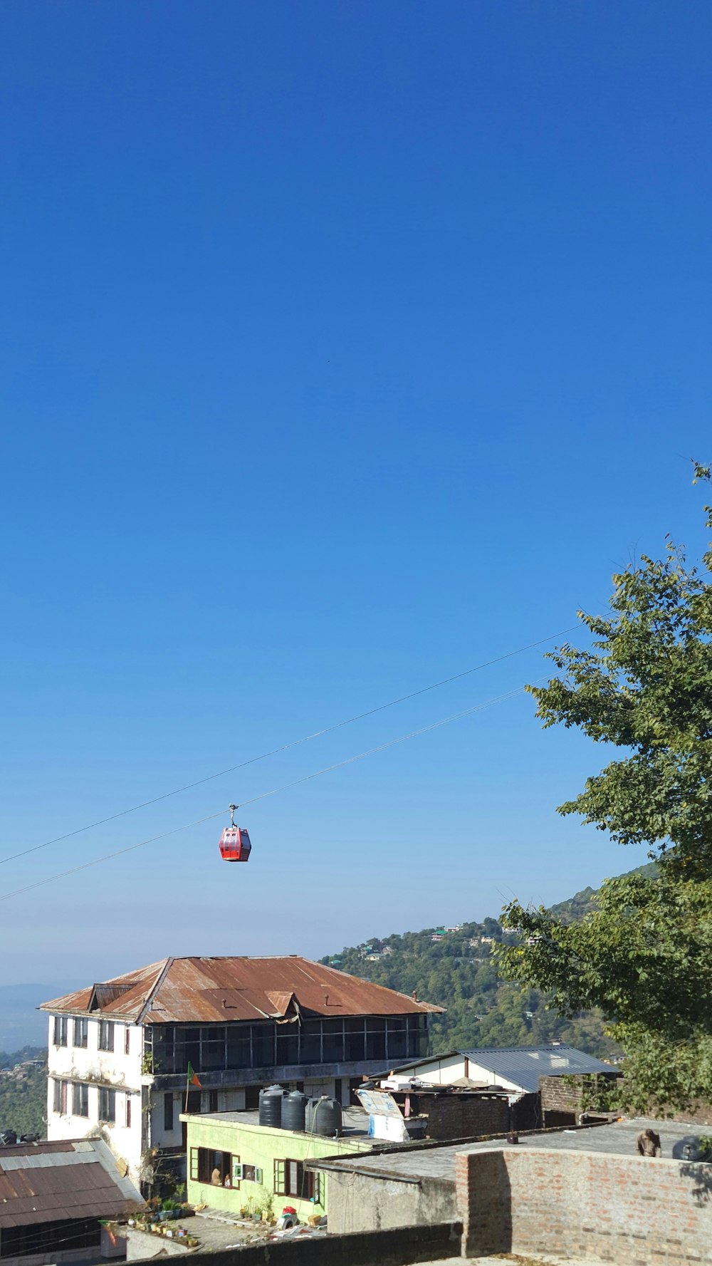 a hot air balloon flying over a building