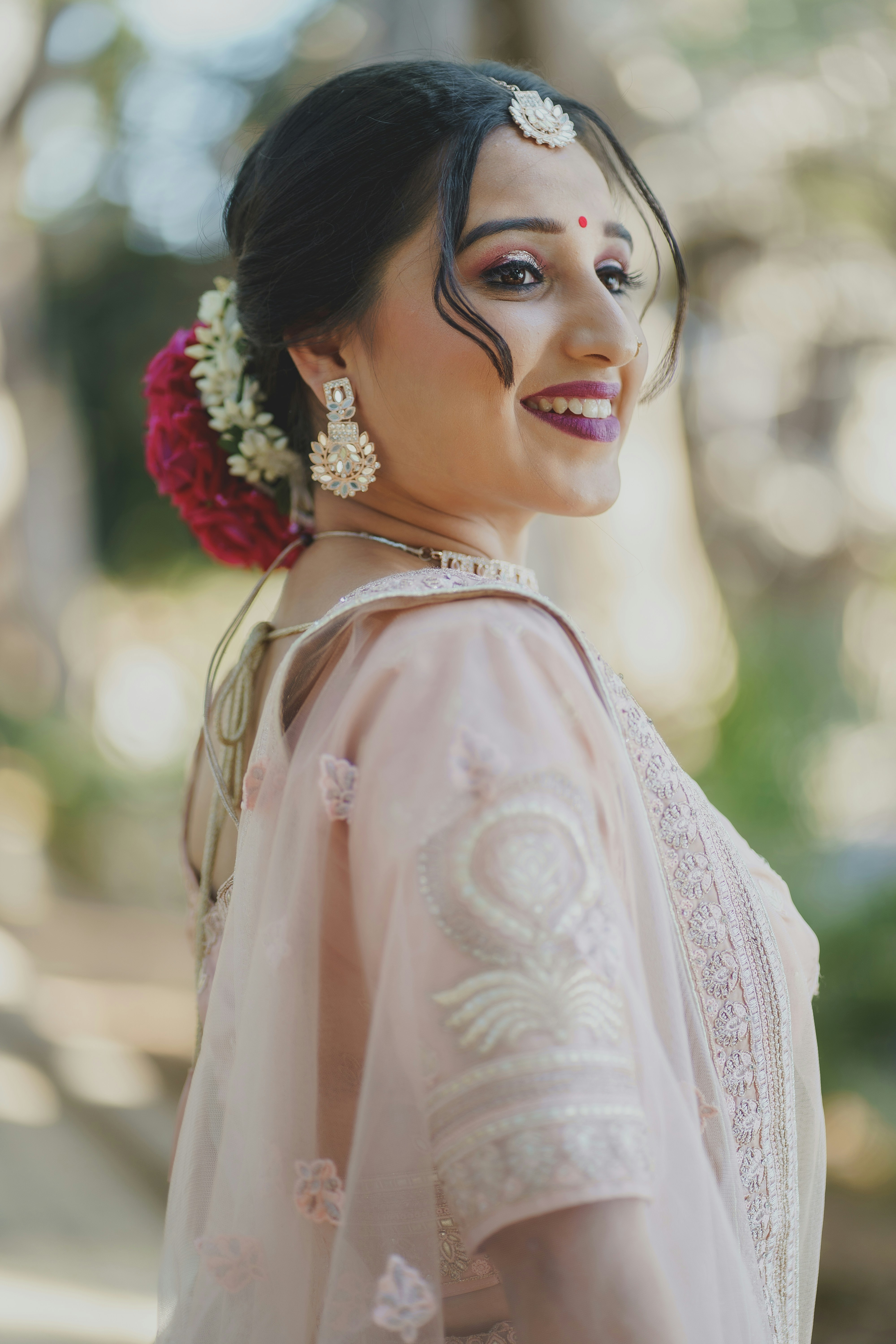 Indian woman with elegant jewelry, warm smiling portrait