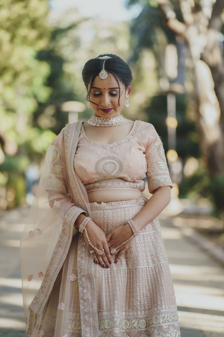 Bride in a blush and ivory lehenga