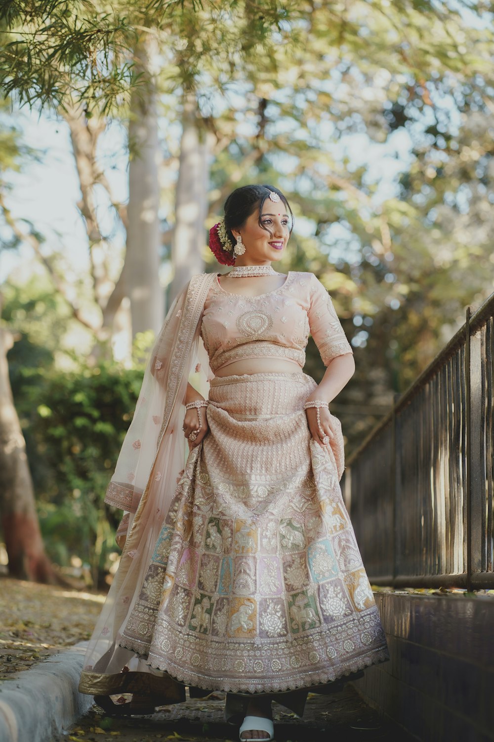 a woman in a wedding dress standing on a bridge
