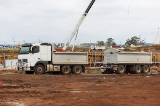 Mobile welding truck parked at a construction site with equipment around.