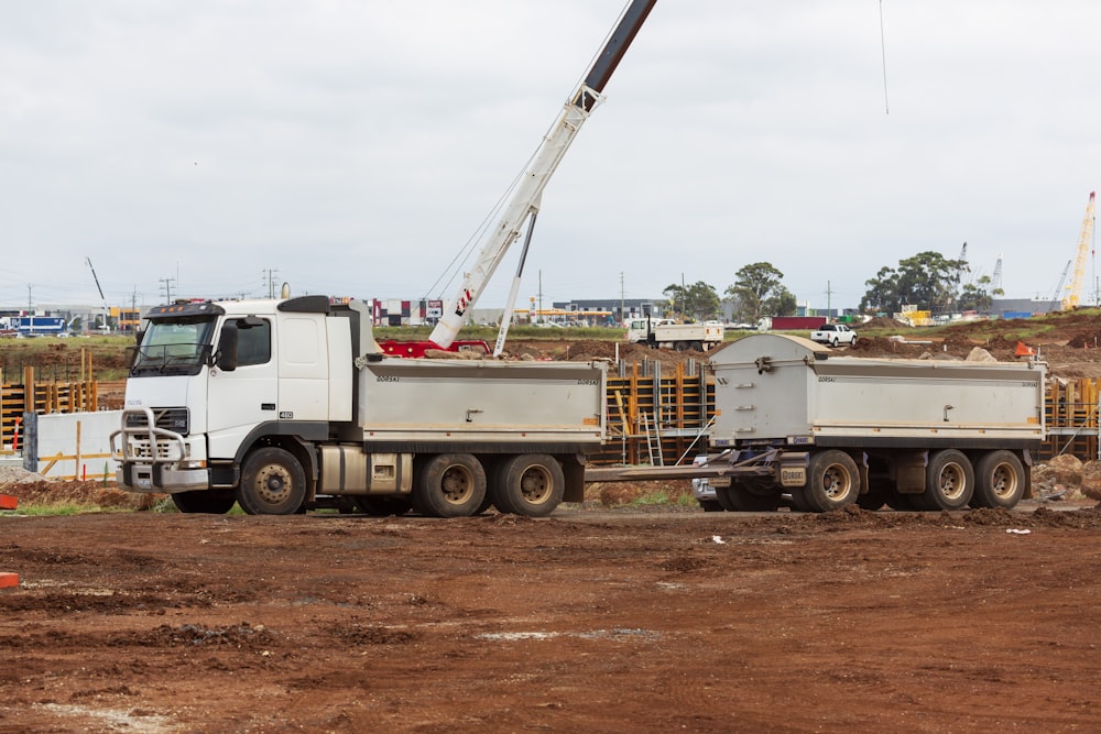 a white truck with a crane on top of it