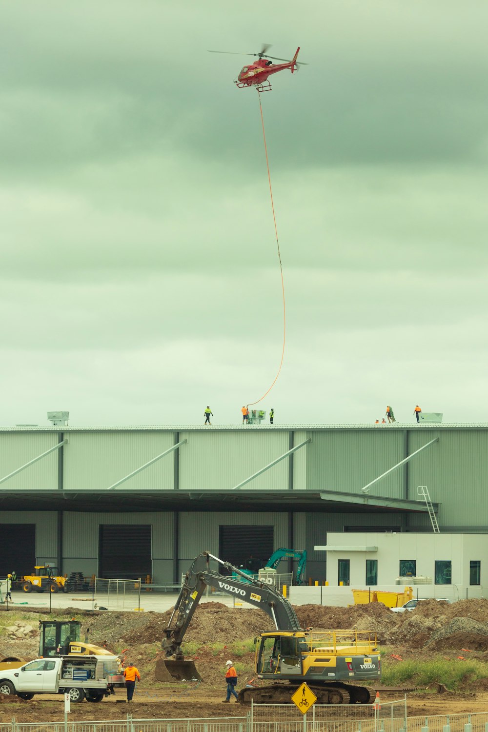 a helicopter is flying over a construction site