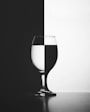 a black and white photo of a wine glass