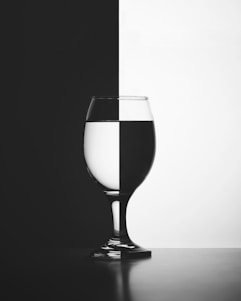 a black and white photo of a wine glass