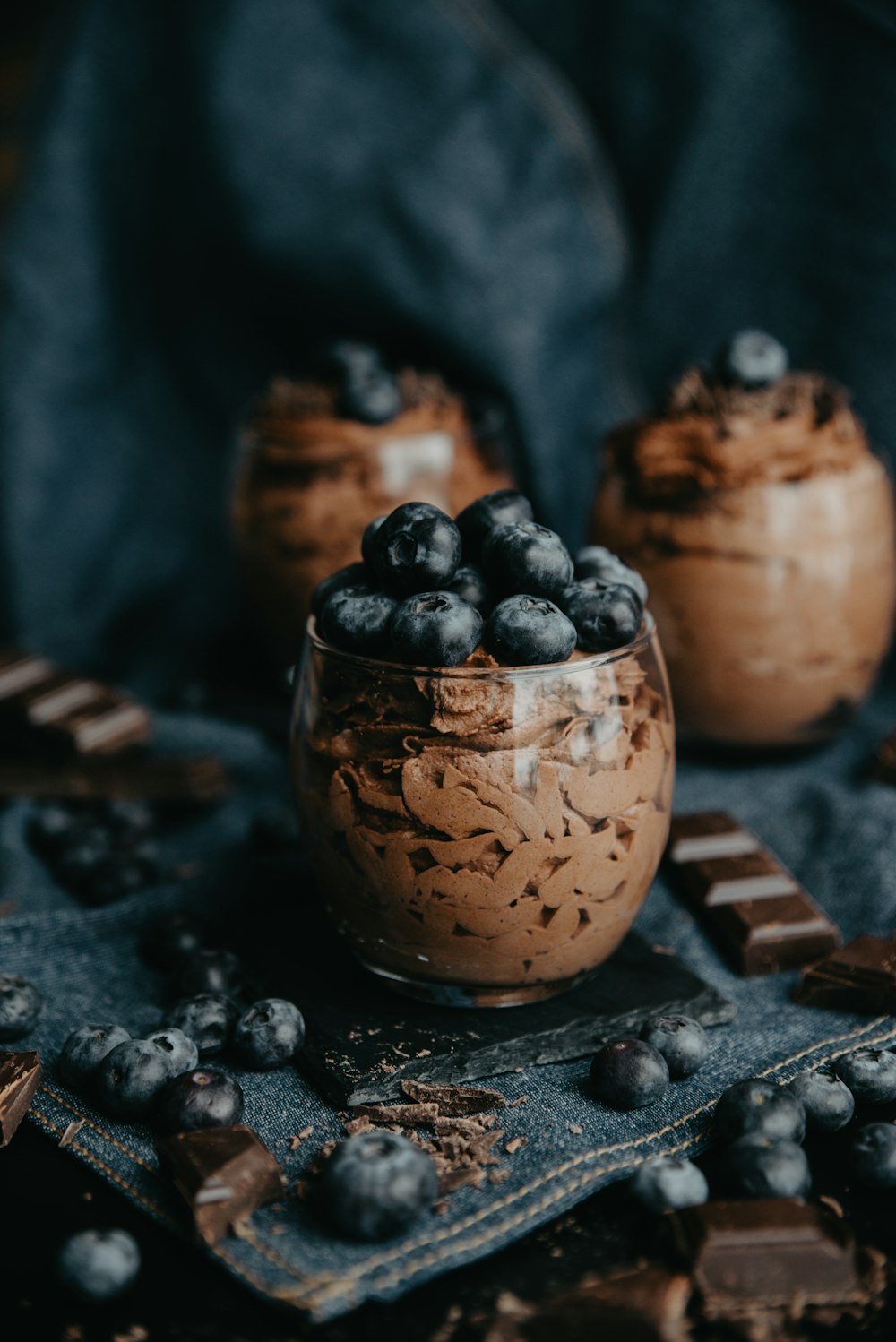 a bowl of chocolate pudding with blueberries on top