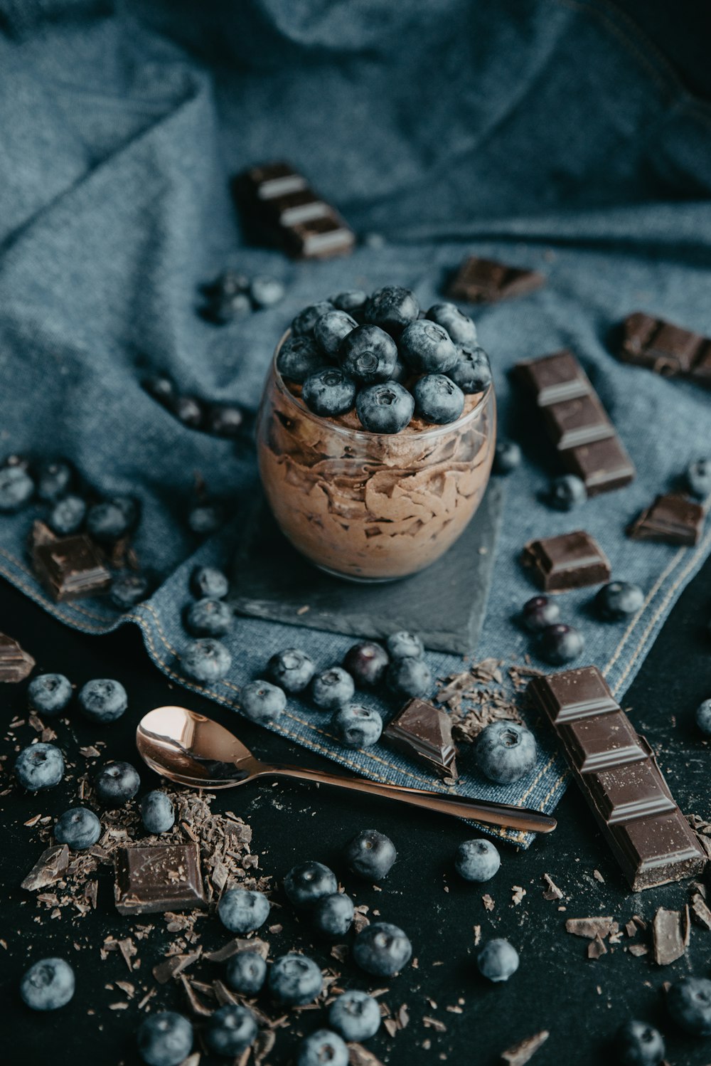 a bowl of blueberries and chocolate on a table