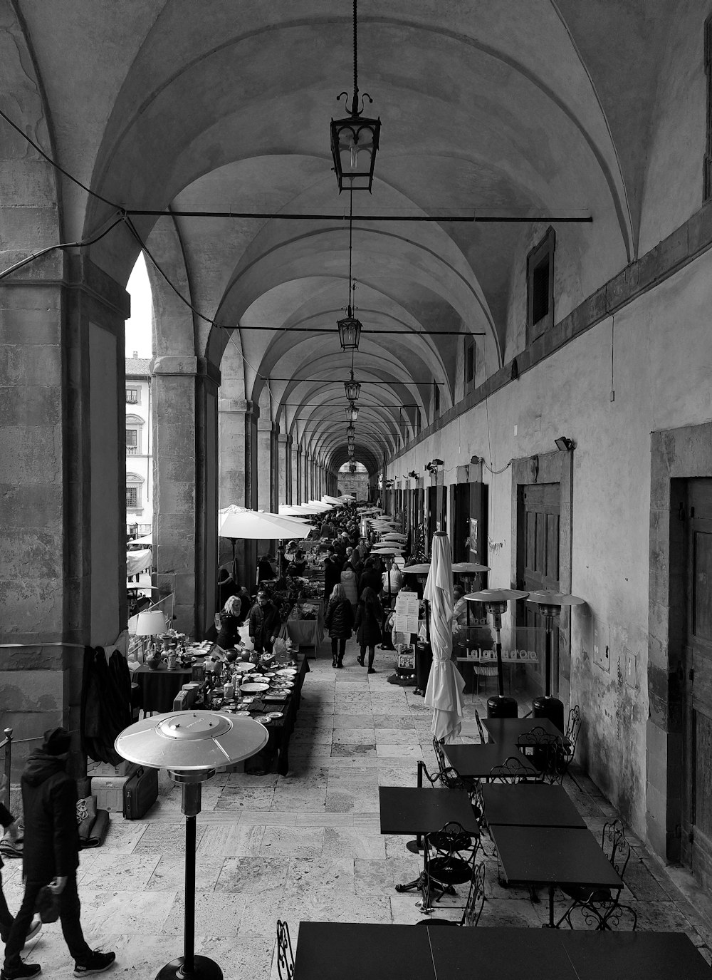 a black and white photo of a long hallway