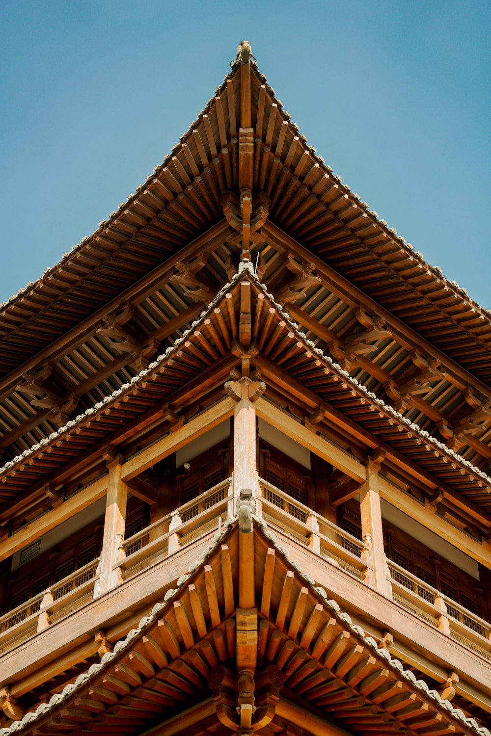 a tall wooden building with a sky background