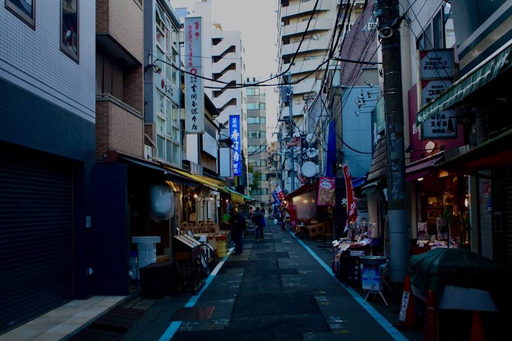 a narrow city street lined with tall buildings