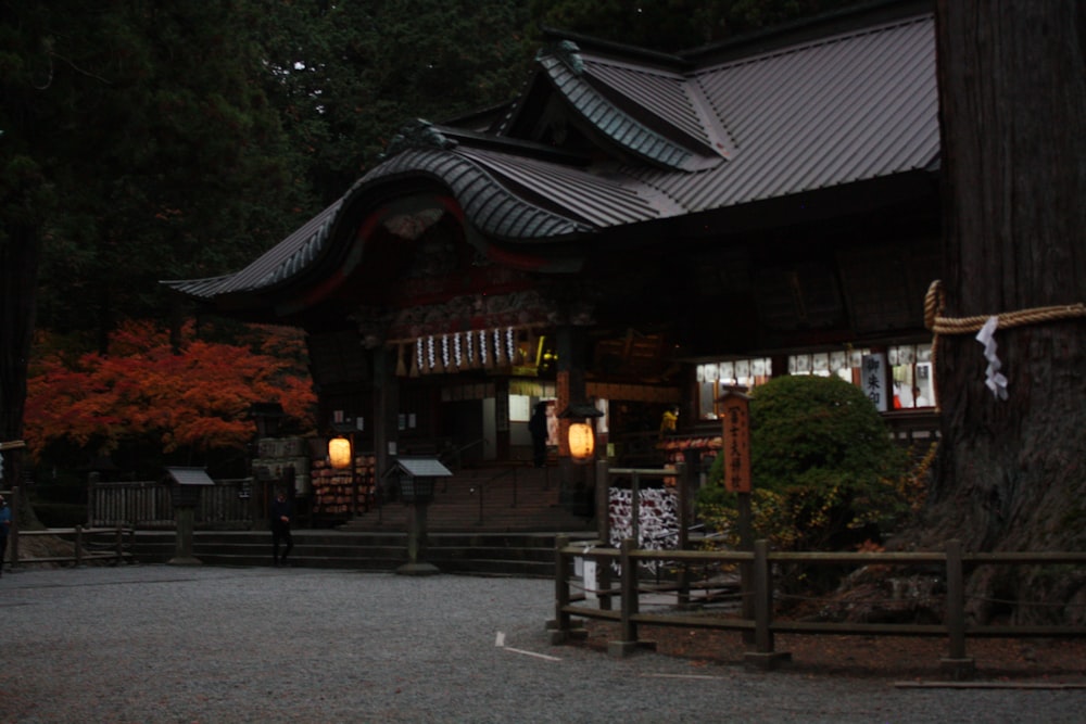 a person walking in front of a building at night