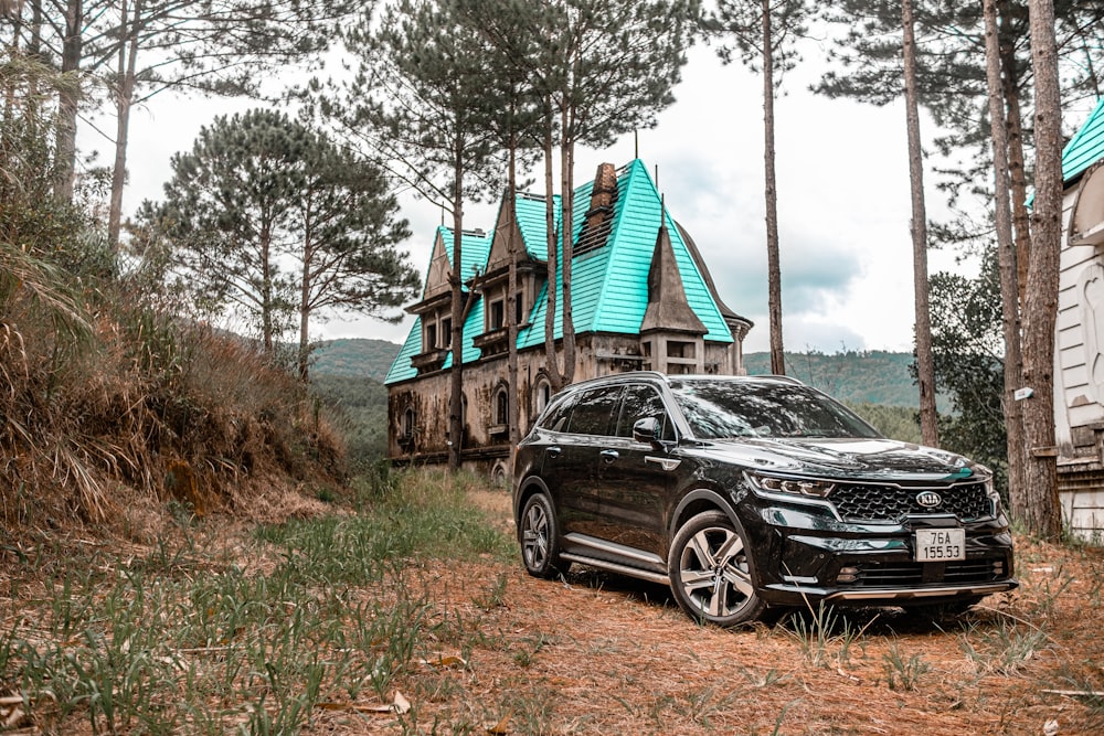 a black car parked in front of a house