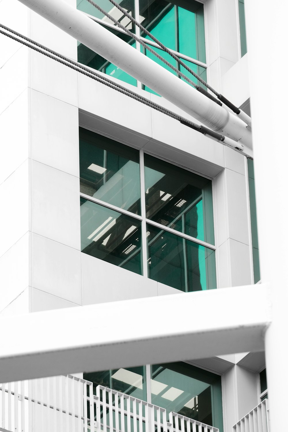 a building with a white fence and a green window