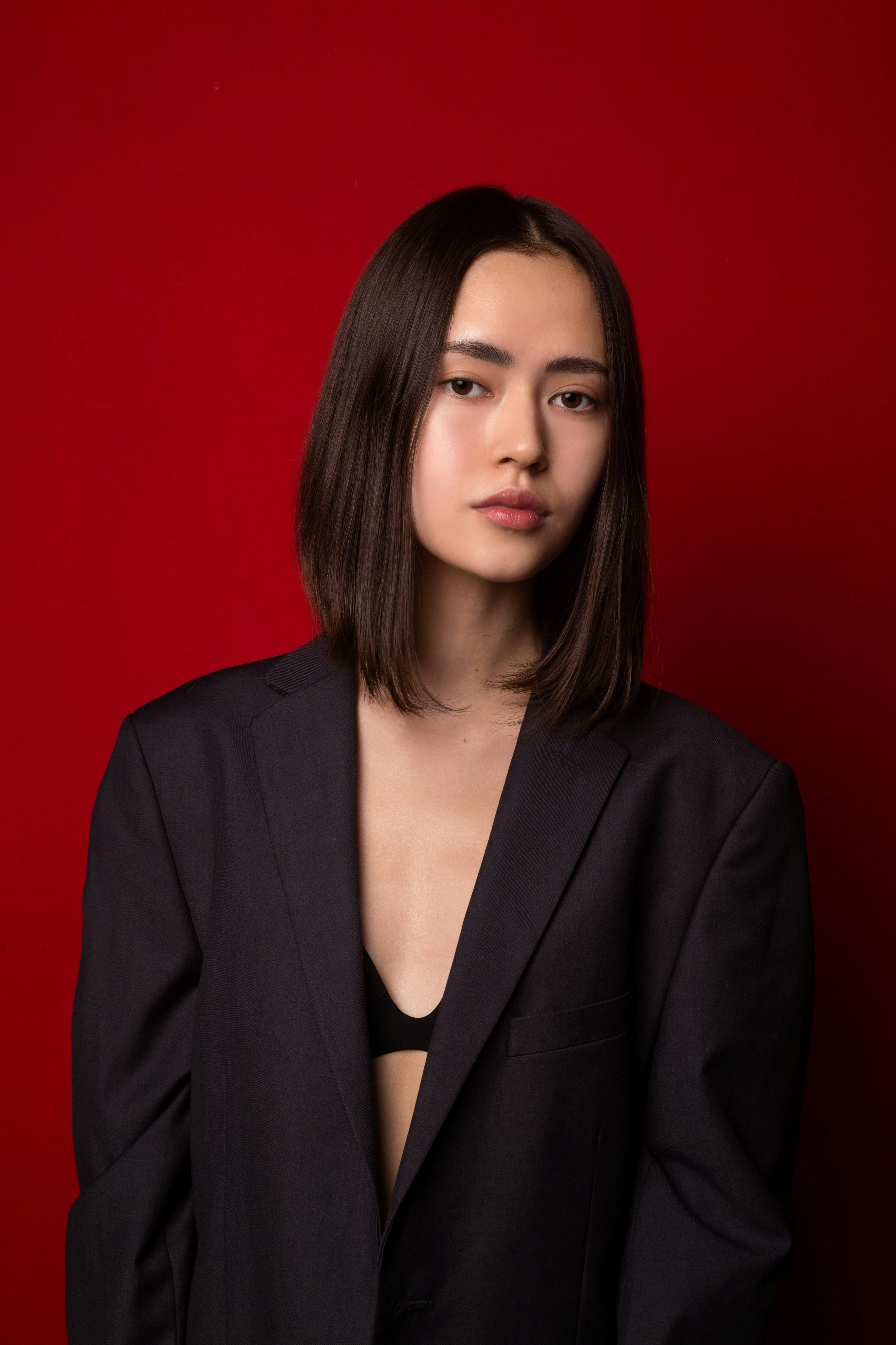 a woman in a black suit posing for a picture