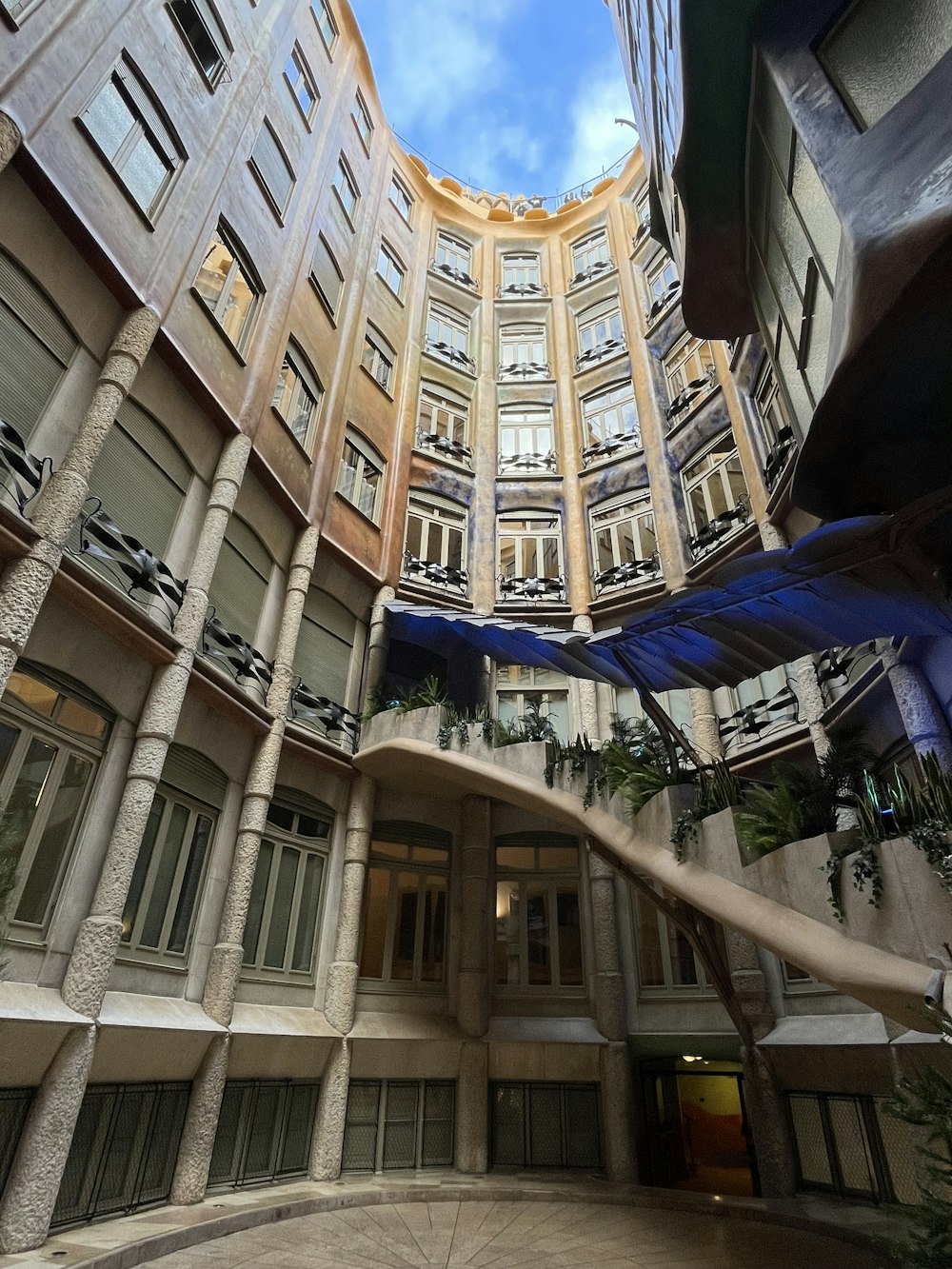 a circular building with many windows and balconies