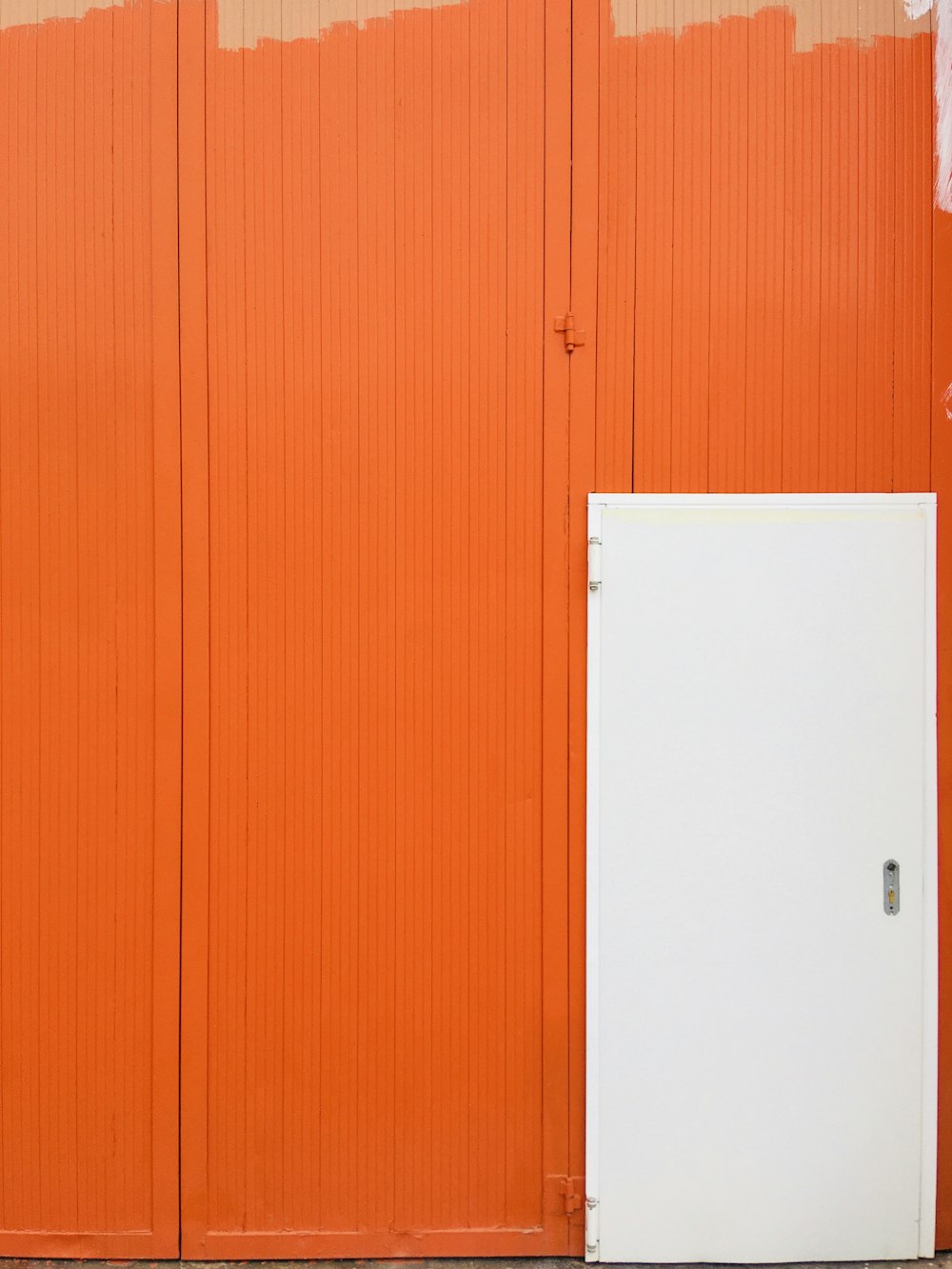 an orange and white building with a white door