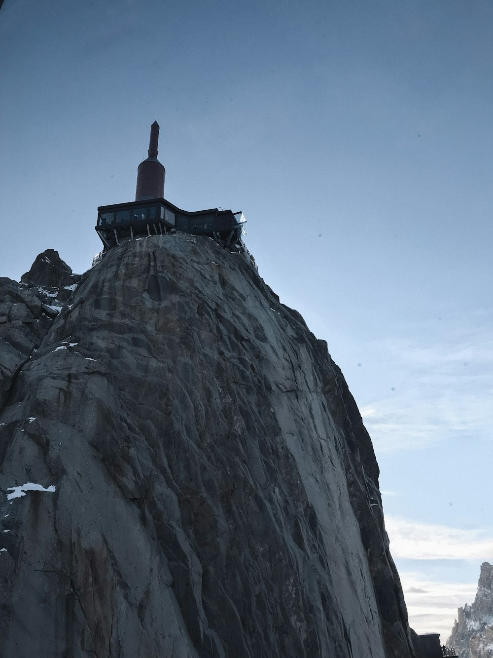 a person standing on top of a large rock