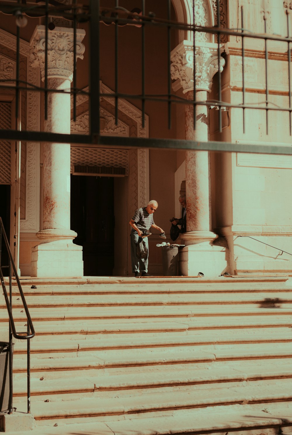 a man is standing on the steps of a building