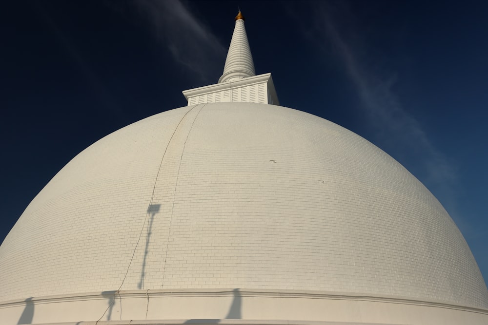 a large white building with a spire on top