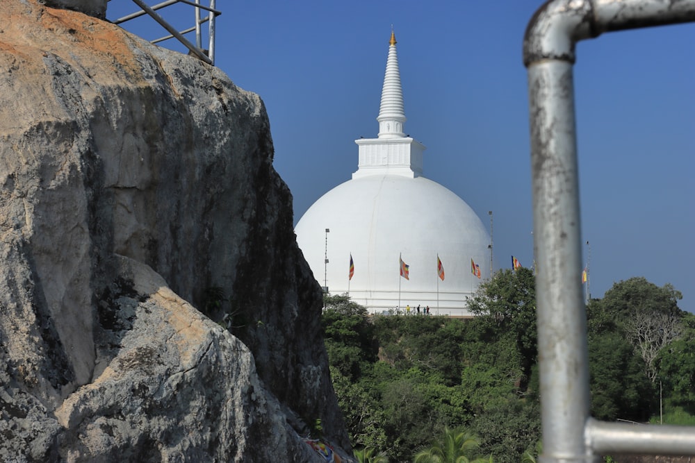 a large white building sitting on top of a mountain