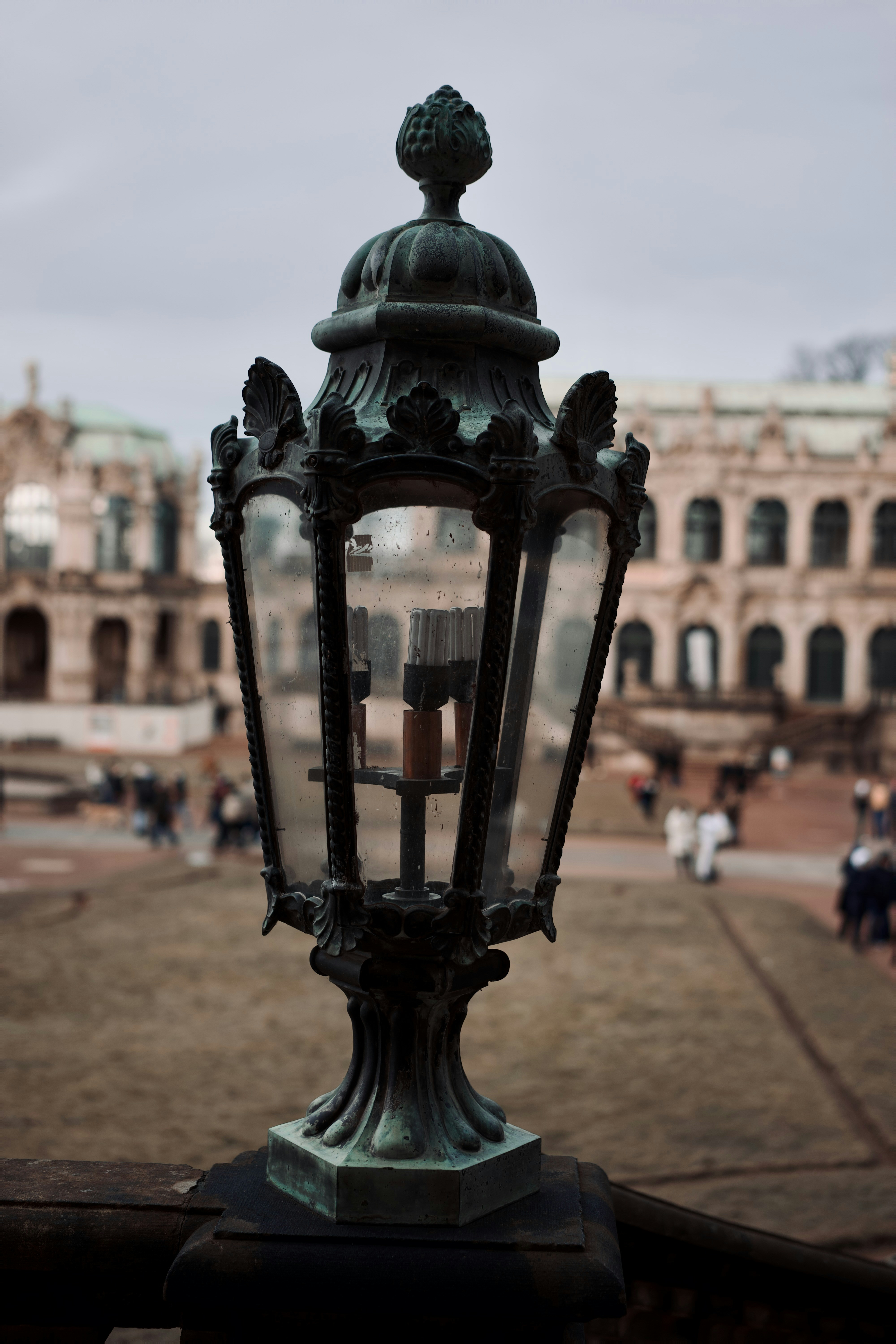 a lamp post with a building in the background