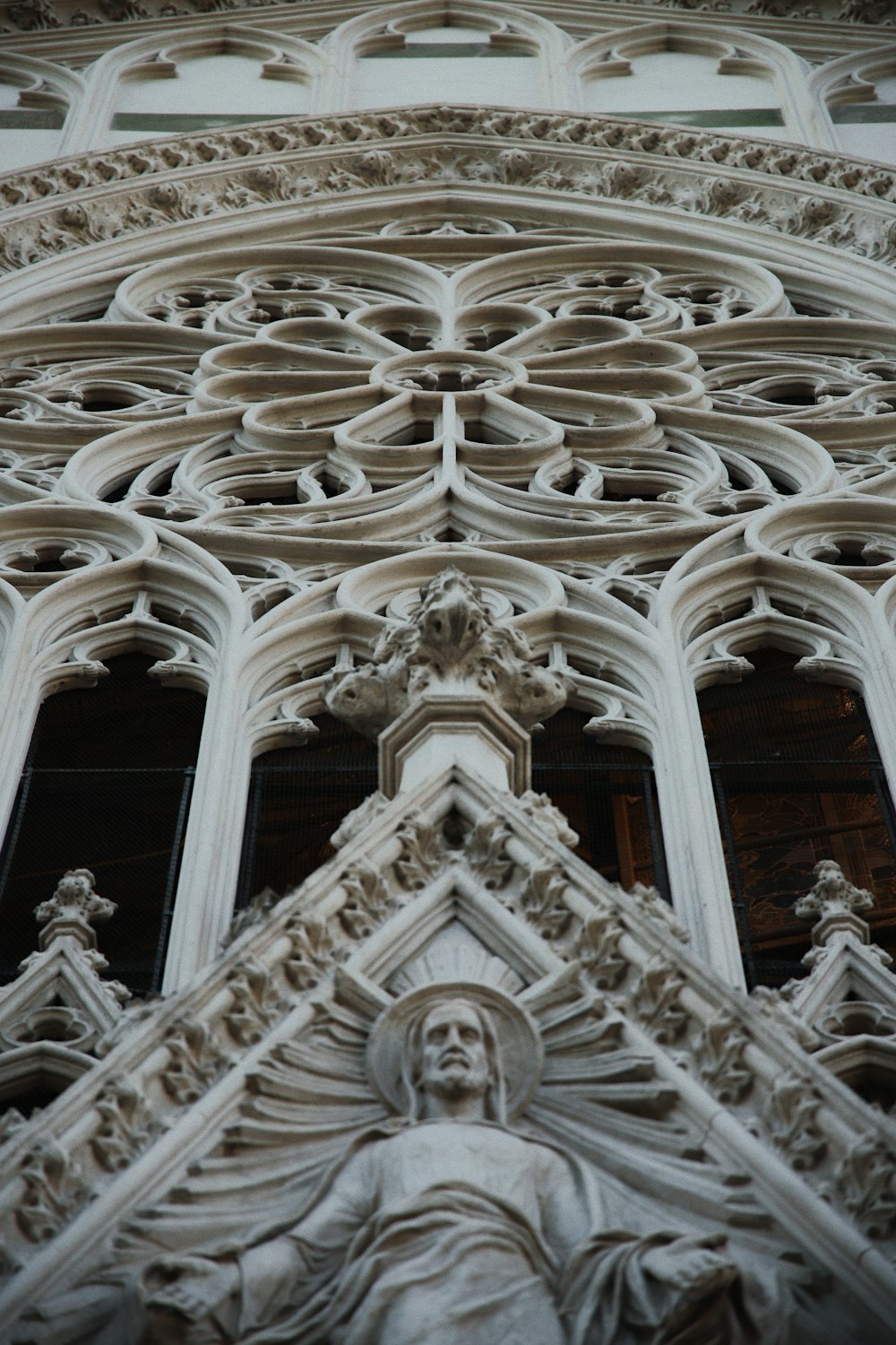 a close up of a very tall building with statues on it