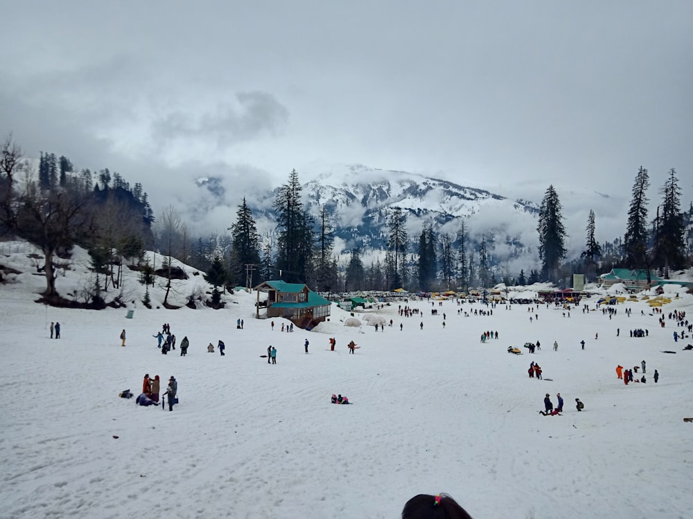 a group of people standing on top of a snow covered slope